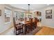Well-lit dining room featuring a large window and hardwood flooring at 14820 E Maplewood Dr, Centennial, CO 80016