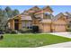 Charming two-story home featuring a three-car garage, landscaped yard, and inviting curb appeal at 14820 E Maplewood Dr, Centennial, CO 80016