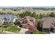Well-maintained two-story home with a manicured lawn and mature trees at 14820 E Maplewood Dr, Centennial, CO 80016