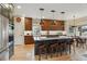 Modern kitchen with stainless steel appliances, granite countertops, kitchen island, and designer lighting at 14820 E Maplewood Dr, Centennial, CO 80016