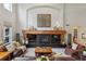Inviting living room with a fireplace, built-in shelving, and comfortable seating arrangement at 14820 E Maplewood Dr, Centennial, CO 80016
