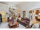 Spacious living room featuring hardwood floors, a cozy seating arrangement, and views of the open floor plan at 14820 E Maplewood Dr, Centennial, CO 80016