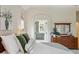 Bright main bedroom featuring stylish decor, a modern bathroom, and a serene color palette at 14820 E Maplewood Dr, Centennial, CO 80016