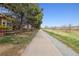 Walking path next to the property, surrounded by trees, bushes and open fields at 14820 E Maplewood Dr, Centennial, CO 80016