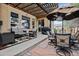 Inviting outdoor patio space with stylish furniture, a grill, a pergola, and serene views at 14820 E Maplewood Dr, Centennial, CO 80016