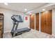 Spacious basement featuring a treadmill, three built-in closets for storage, and neutral carpeting at 9580 E 5Th Ave, Denver, CO 80230