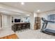 Finished basement with a treadmill, custom bar, and entertainment area at 9580 E 5Th Ave, Denver, CO 80230
