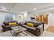 Finished basement with a brown leather sectional sofa, coffee table, and convenient access to storage at 9580 E 5Th Ave, Denver, CO 80230