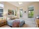 Comfortable bedroom featuring lots of light and a colorful throw at 9580 E 5Th Ave, Denver, CO 80230