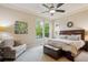 Main bedroom with plush carpet, natural lighting and tray ceiling at 9580 E 5Th Ave, Denver, CO 80230