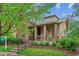 Attractive two-story home with a covered front porch, lush landscaping, and inviting curb appeal in a prime location at 9580 E 5Th Ave, Denver, CO 80230