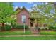 Charming brick home with well-manicured lawn and a welcoming front porch at 9580 E 5Th Ave, Denver, CO 80230