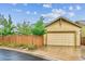 Attached two-car garage with a paved driveway, offering convenient parking and storage solutions for residents at 9580 E 5Th Ave, Denver, CO 80230