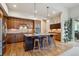 Beautiful kitchen featuring hardwood floors, granite countertops, and a central island with bar seating at 9580 E 5Th Ave, Denver, CO 80230