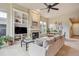 Open-concept living area with a fireplace, dining area and comfortable seating at 9580 E 5Th Ave, Denver, CO 80230