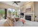 Spacious living room with a fireplace and large windows, offering a bright and airy ambiance at 9580 E 5Th Ave, Denver, CO 80230
