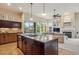 Open concept kitchen with granite island leading to the living room featuring a fireplace at 9580 E 5Th Ave, Denver, CO 80230