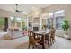 Bright living room with a fireplace, large windows, and an adjacent dining area at 9580 E 5Th Ave, Denver, CO 80230