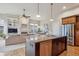 Open concept living area showcasing a granite island kitchen, fireplace, and adjacent dining area at 9580 E 5Th Ave, Denver, CO 80230