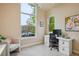 Cozy office space with a large window allowing natural light, plus desk with drawers and rolling chair at 9580 E 5Th Ave, Denver, CO 80230