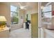 Bright home office featuring a large window, ceiling fan, and neutral décor at 9580 E 5Th Ave, Denver, CO 80230