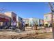 Charming town center with outdoor seating, umbrellas, and storefronts under a bright blue sky at 9580 E 5Th Ave, Denver, CO 80230