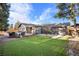 Spacious backyard featuring a deck with seating and well-maintained artificial grass at 9783 Zephyr Dr, Broomfield, CO 80021