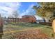 A backyard featuring artificial turf, a wooden pergola, and a two-story wood building, under a blue sky with scattered clouds at 9783 Zephyr Dr, Broomfield, CO 80021