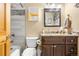 Bathroom showcasing a shower with mosaic tile, gray tile, and a granite countertop at 9783 Zephyr Dr, Broomfield, CO 80021