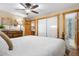 Cozy bedroom showcasing wood trim, an open bathroom doorway, and a closet with sliding doors at 9783 Zephyr Dr, Broomfield, CO 80021