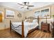 Charming bedroom features a ceiling fan, two windows with shutters, and hardwood floors at 9783 Zephyr Dr, Broomfield, CO 80021