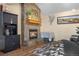 Close up of the fireplace, including the stone surround and wooden mantle at 9783 Zephyr Dr, Broomfield, CO 80021