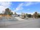 Charming single-story home with a circular driveway and mature trees on a sunny day at 9783 Zephyr Dr, Broomfield, CO 80021