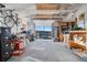 Garage featuring an open door, workspace, and storage at 9783 Zephyr Dr, Broomfield, CO 80021