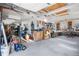 Garage space with workbenches, shelves, a punching bag, and exercise equipment at 9783 Zephyr Dr, Broomfield, CO 80021