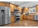 Kitchen featuring stainless steel appliances, custom cabinets, and hardwood floors at 9783 Zephyr Dr, Broomfield, CO 80021