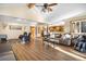 Open concept living room with vaulted ceilings, wood floors and a large sectional sofa at 9783 Zephyr Dr, Broomfield, CO 80021