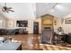 Open living room with a stone fireplace, wood floors, vaulted ceilings, and lots of natural light at 9783 Zephyr Dr, Broomfield, CO 80021