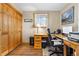 Bright office featuring hardwood floors, a desk, and a large storage closet at 9783 Zephyr Dr, Broomfield, CO 80021