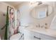 Updated bathroom features a modern vanity with a new sink and a tiled shower at 3964 S Yosemite St, Denver, CO 80237