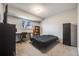 Neutral bedroom featuring carpeted floors, a desk, bookshelf, and window at 3964 S Yosemite St, Denver, CO 80237