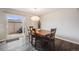 Open dining room with a large wooden table, stylish light fixture, and access to the patio at 3964 S Yosemite St, Denver, CO 80237