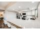 Bright kitchen with white cabinetry, stainless steel appliances, and a large counter at 3964 S Yosemite St, Denver, CO 80237