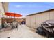 Private patio featuring an umbrella-covered table and chairs, along with storage at 3964 S Yosemite St, Denver, CO 80237