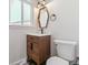 Modern bathroom with hexagon mirror and wood vanity at 7649 E Amherst Ave, Denver, CO 80231