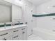 Bathroom with double vanity, subway tile, and bathtub at 7649 E Amherst Ave, Denver, CO 80231