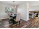 Dining room with a dark wood table and light beige chairs at 7649 E Amherst Ave, Denver, CO 80231