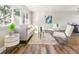 Living room with light-colored sofa and hardwood floors at 7649 E Amherst Ave, Denver, CO 80231