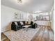 Living room with sectional sofa, coffee table, and hardwood floors at 7649 E Amherst Ave, Denver, CO 80231