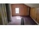 Cozy bedroom with wood walls, a window providing natural light, and soft purple carpet at 605 Argentine St, Georgetown, CO 80444